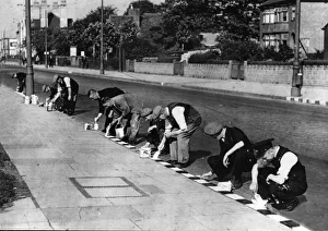 Painting Prints: White squares being painted on curb stone edges along the main Birmingham Coventry Road