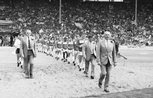 00351 Prints: Widnes and Wigan walk out on to the pitch for the first time lead by their resceptive
