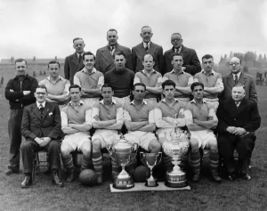 Team Prints: Wigan Athletics football team poses for a group photograph with their three cups