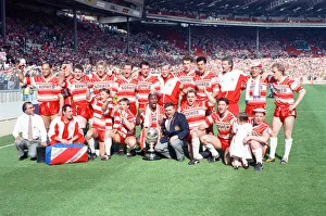 The Wigan team celebrate their 36 -14 victory over Warrington in the Rugby League Cup