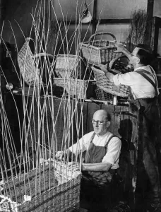 Dungarees Prints: Wil Preedy sits cross legged making a hamper basket while his brother Arthur sorts out