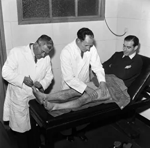 Treatment Prints: Wilf Dixon (centre), Southend United Trainer massages player Sam McCrory on the treatment