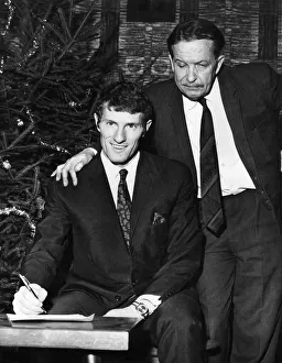 Willie Stevenson. Chairman of State Albert Henshall watches as Wille Stevenson signs for