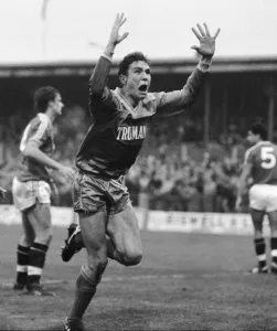 Amazement Prints: Wimbledon footballer Vinnie Jones raises his arms as he celebrates scoring the game