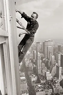 Window Cleaners a 1000 foot above the side walk cleaning the windows of the Empire State
