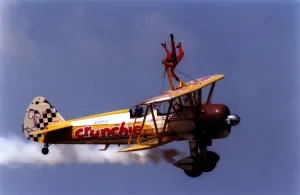 A wing walker performs on the Cadburys Crunchie Boeing-Stearman Model 75 biplane