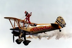 00385 Prints: A wing walker performs on the Cadburys Crunchie Boeing-Stearman Model 75 biplane