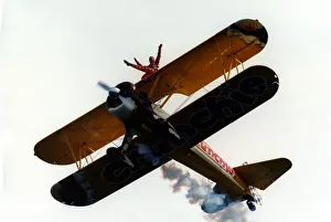 A wing walker performs on the Cadburys Crunchie Boeing-Stearman Model 75 biplane