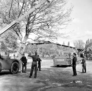 The wings being attached to a Folland Gnat of the Red Arrows in preparation for a Royal