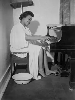 Bowl Prints: Winifred Atwell, pianist, seen here rehearsing after warming up both her hands and feet