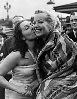 The winner, Connie Tilton, kisses her loosing rival on Westminster Pier after the race