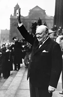 Winston Churchill British Prime Minister holding his fingers up in a V for victory sign