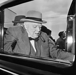 00719 Prints: Winston Churchill pictured at London airport as he returns to England from holiday in