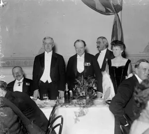 Winston Churchill stands alongside United States Ambassador to the United Kingdom John W