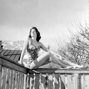 Swimming Costumes Prints: Winter Olympic Games 1956 A model wearing swimwear posing on a balcony