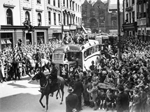 Wolverhampton Wanderers players show the FA Cup trophy to their fans from atop an open