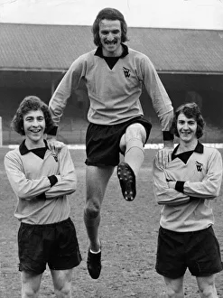Wolves striker Derek Dougan swings between team mates Alan Sunderland (left
