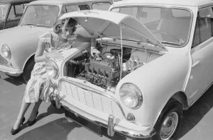 00102 Prints: A woman checks the engine of one of the first mini cars designed by Alec Issigonis which