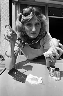 Images Dated 25th June 1976: A woman cooks an egg on a car bonnet during the 1976 heatwave. 25th June 1976
