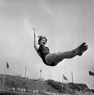 Swimsuit Prints: Woman diving into a swimming pool on holiday July 1953 D3732