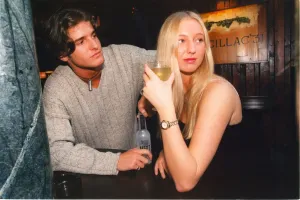 A woman fighting off the advances of a man in the pub - sexual harrassment