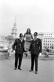 Woman being held up by two policemen in Trafalgar Square, London. October 1969 Z10351-001