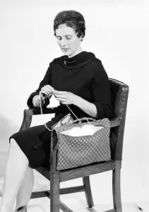 Armchair Prints: Woman knitting pose in the Daily Mirror studios Circa 1959