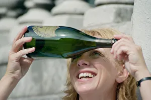 A woman in Liverpool city centre watching the solar eclipse through a bottle