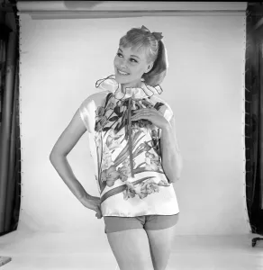 Woman modelling floral blouse. Circa 1960