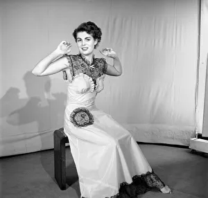 Woman modelling the latest evening dress fashions in the Reveille studios