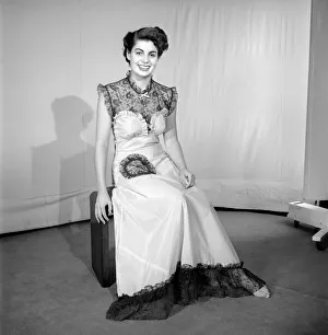Woman modelling the latest evening dress fashions in the Reveille studios
