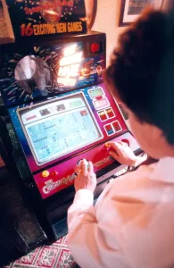 00101 Prints: A woman playing on a one armed bandit or electronic gaming machine in November 1999