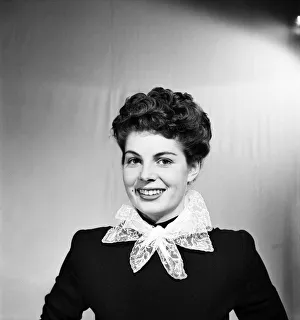 00026 Prints: Woman poses wearing a neck scarf. October 1952 C6276