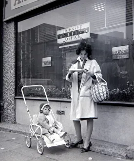 A woman punter studies the form guide outside A E Fane and Co betting shop in islington