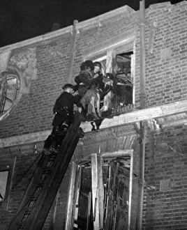 A woman being rescued from a block of flats damaged by a V bomb in Southern England
