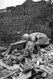 00168 Prints: A woman rummages through the debris of bomb damage at New Cross after air raids on London