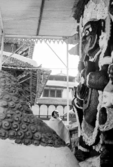 Hinduism Prints: A woman seen here looking at a depiction of a Hindu god on the facade of a Hindu temple