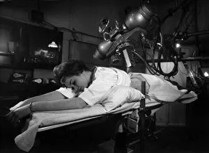 00097 Prints: Woman undergoing a cancer check at an X ray unit in a London hospital
