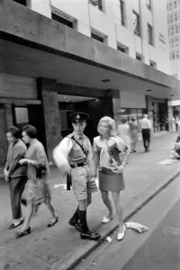 Woman on a visit to Hong Kong for a shopping trip asks a policeman for directions