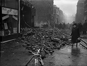 A woman on her way to work negotiates the rubble strewn Smallbrook Street