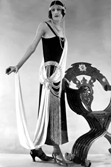 00371 Prints: Woman wearing black dress with pearl bead detail at the waist and as a headdress