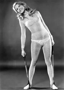 Fitness Prints: Woman wearing bra and knickers and see through dress stretching as part of her fitness
