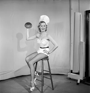 Skimpy Prints: Woman wearing chefs hat holding loaf of bread. 1959 E61-002