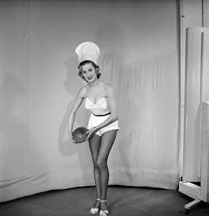Woman wearing chefs hat holding loaf of bread. 1959 E61-005