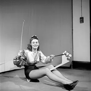Woman wearing fancy dress jockey outfit. 1959