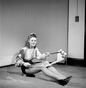 Woman wearing fancy dress jockey outfit. 1959