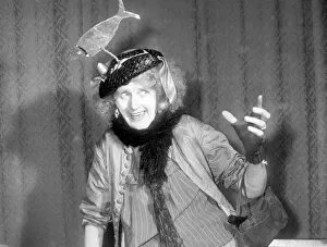 00177 Prints: Woman wearing a hat with a fish on it. Singer performing on stage