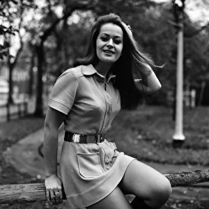 Woman wearing mini dress with belt across the waist and knee high boots