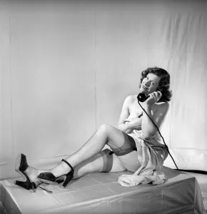 Woman wearing stockings seen here on the telephone. 1959