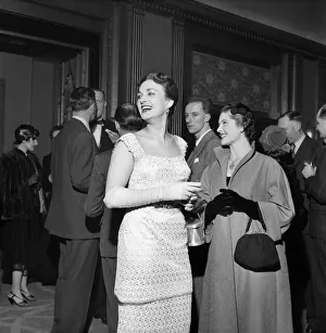 00026 Prints: Woman wearing a white dress talking to other people at a cocktail Party